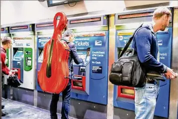  ?? Getty Images ?? People buy Metrocards at Grand Central Station in New York City.