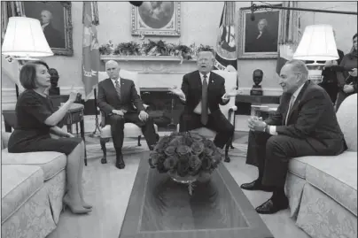  ?? The Associated Press ?? SHOWDOWN: President Donald Trump and Vice President Mike Pence meet with Senate Minority Leader Chuck Schumer, D-N.Y., and House Minority Leader Nancy Pelosi, D-Calif., on Tuesday in the Oval Office of the White House in Washington. Congress is racing to avoid a partial government shutdown over President Donald Trump’s border. But you wouldn’t know it by the schedule. Lawmakers are away until next week. The ball is in Trump’s court, both sides say.