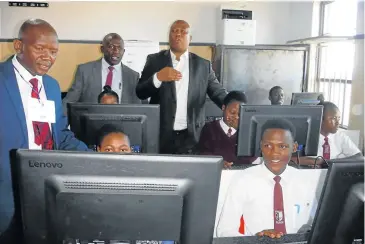  ?? Picture: SIKHO NTSHOBANE ?? KEY TO THE FUTURE: Ngcobo mayor Siyabulela Zangqa, Sthoza High School principal Mqondiso Ndyalvane and Eastern Cape finance MEC Oscar Mabuyane watch pupils at work in their new computer lab at the school in Ngcobo.