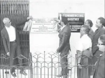  ??  ?? President David Granger (left) and Attorney General Basil Williams during the commission­ing of the building housing the Commercial Registry