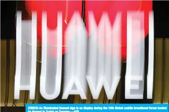  ?? —AFP ?? ZURICH: An illuminate­d Huawei sign is on display during the 10th Global mobile broadband forum hosted by Huawei in Zurich on Tuesday.