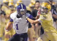  ??  ?? Manzano’s Jordan Byrd (1) is forced out of bounds by Atrisco Heritage’s Logan Chavez (23) in the first half.