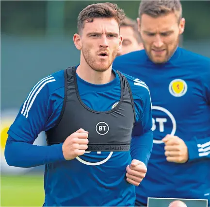  ??  ?? Skipper Andy Robertson leads the way in a Scotland training session.