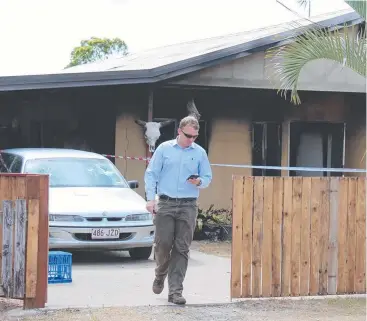  ??  ?? LOST EVERYTHING: A detective leaves the Amos St, Cooktown, house that was gutted by fire yesterday. A 38-year-old man has been charged with nine offences including arson.