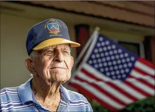  ?? RICHARD GRAULICH / THE PALM BEACH POST ?? Edward Sicard, a 99-year-old WWII veteran who will turn 100 on Nov. 1, stands outside his home in Greenacres. Sicard plays bridge every Monday with three ladies.