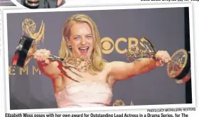  ??  ?? PHOTO:LUCY NICHOLSON/ REUTERS Elizabeth Moss poses with her own award for Outstandin­g Lead Actress in a Drama Series, for The Handmaid’s Tale, and also the Outstandin­g Drama Series trophy won by the show