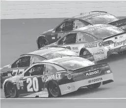  ?? Associated Press ?? n Matt Kenseth (20), Erik Jones (77), Kyle Larson (42) and Martin Truex Jr. (78) head into turn one on the last restart of the NASCAR Cup Series auto race Sunday in Brooklyn, Mich.