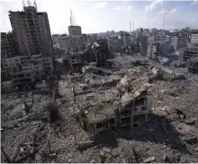  ?? ?? Buildings destroyed by an Israeli air strike on Gaza city on October 10, three days after the war started AP