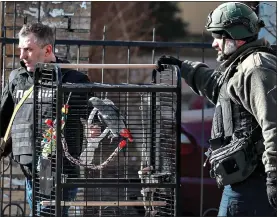  ?? ?? TAKING FLIGHT: Police save a parrot from a shell-damaged building in Kyiv