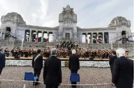  ?? AP ?? Italian President Sergio Mattarella, center, speaks in front of Bergamo's cemetery on Sunday. Italy bid farewell to its coronaviru­s dead on Sunday with a haunting Requiem concert performed at the entrance to the cemetery of Bergamo.