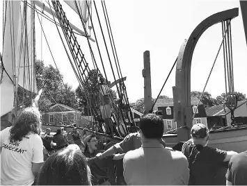  ??  ?? Mystic Seaport visitors pitch in to help staffers haul up a whaleboat on the Charles W. Morgan. – New England’s “Melville Triangle.”