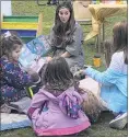  ?? ?? Local author Paige Hunt reads her book “Bubble Baby” at the MAEVE Northern Calvert community book swap.