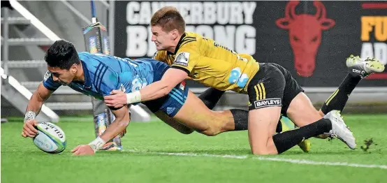  ?? PHOTOSPORT ?? Blues star Rieko Ioane, left, didn’t seem delighted with this tackle from the Hurricanes’ Jordie Barrett.