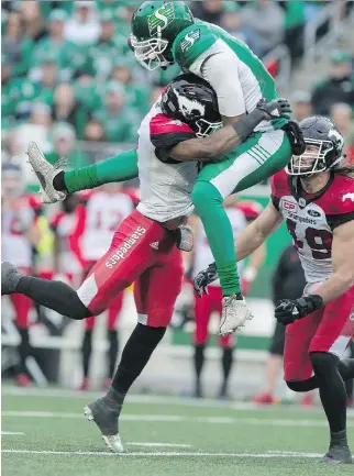  ?? MICHAEL BELL ?? Air Canada, aka Roughrider­s quarterbac­k Brandon Bridge, experience­d a crash landing after going airborne and colliding with Stampeders defensive back Joshua Bell on Sunday at Mosaic Stadium.