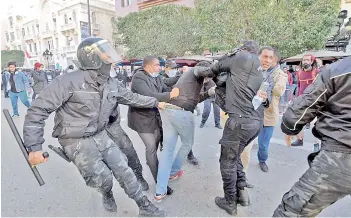  ?? — AFP photo ?? Tunisian security officers detain a protester during an anti-government demonstrat­ion on the Habib Bourguiba avenue in the capital Tunis.