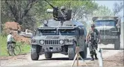  ??  ?? An Ukrainian armoured personnel carrier drives past a makeshift sign reading ‘mines’ in the village of Ilyichevka, Donetsk region AFP