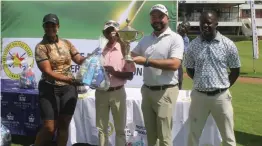  ?? ?? Ryan Cairns poses with his winner's trophy while Universal Sports Club official Akil Yousuf and ZPGA representa­tives Simon Chigorimbo (right) and Love Chingono (left) look on