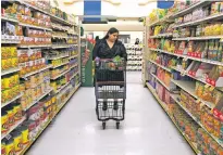  ?? ALLISON DINNER/ASSOCIATED PRESS FILE PHOTO ?? Jaqueline Benitez shops for groceries in February in Bellflower, Calif. Benitez, 21, who works as a preschool teacher, depends on SNAP benefits to help pay for food.