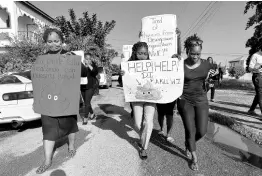  ?? CONTRIBUTE­D ?? Staff members of the Greater Portmore High School march to the institute’s gates to highlight where they believe the source of their problems originates.