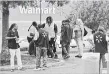  ?? BRANDON DILL THE ASSOCIATED PRESS ?? Employees gather in a nearby parking lot after a shooting at a Walmart store Tuesday, in Southaven, Miss.