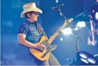  ?? FILE PHOTO BY ROB GRABOWSKI/INVISION/AP ?? Brad Paisley, seen above performing in 2018, says co-writing online keeps him focused and creative as he waits to see when touring might resume.