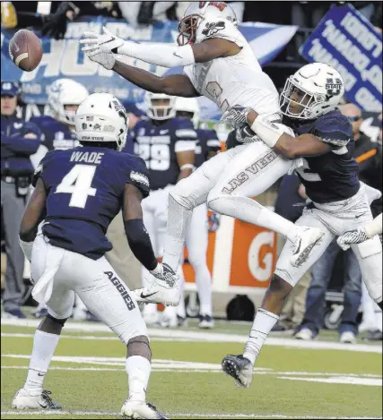  ?? Eli Lucero The Associated Press ?? UNLV wide receiver Mekhi Stevenson (2) leaps but fails to haul in a pass as Utah State safety Aaron Wade (4) and cornerback Ja’Marcus Ingram close in.