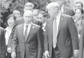  ?? ASSOCIATED PRESS ?? US President Donald Trump, right, and Russia's President Vladimir Putin talk during the family photo session at the APEC Summit in Danang, Vietnam.