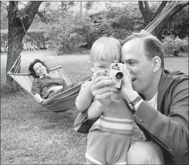  ?? Börres Weiffenbac­h (top); Lennart Nilsson Picture-Alliance (above) ?? INGMAR BERGMAN relaxes with his fourth wife, Kabi Laretei, and their son, Daniel, who discusses his famous father in “Searching for Ingmar Bergman.” At top, Liv Ullmann, left, talks with documentar­y director Margarethe von Trotta.