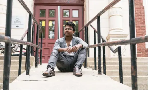  ?? MAX HERMAN/ FOR THE SUN- TIMES ?? Salamat Khan Bin Jalil Khan sits outside Sullivan High School, where he recently finished his sophomore year.