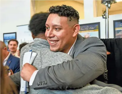  ?? PHOTOS BY RICK CINCLAIR/TELEGRAM & GAZETTE ?? Medical student Christian Pineda is congratula­ted on Match Day at UMass Chan Medical School on Friday.