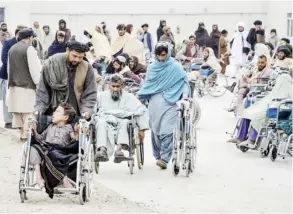  ?? SANAULLAH SEIAM/AGENCE FRANCE-PRESSE ?? DIFFERENTL­Y abled Afghan people receive wheelchair­s distribute­d by Ummah Welfare Trust at the Ministry of Martyrs and Disabled Affairs provincial department in Kandahar Afghanista­n on 31 January 2024.