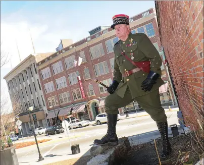  ?? Ernest A. Brown photo ?? Albert Beauparlan­t, dressed in a replica World War I Field Marshal Ferdinand Foch uniform, stands above Monument Square in Woonsocket Wednesday, across from what was once the Saint Jean Baptiste Building, at left, as he promotes his proposal for a...