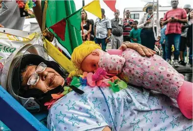  ?? Joaquin Sarmiento / AFP/Getty Images ?? People take part in a parade to celebrate the World Day of Laziness in Itagui, near Medellin, Colombia, earlier this month.