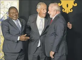  ?? Armando Franca Associated Press ?? PORTUGUESE President Marcelo Rebelo de Sousa is f lanked by Mozambique’s Filipe Nyusi, left, and Brazil’s President-elect Luis Inácio Lula da Silva in Lisbon.