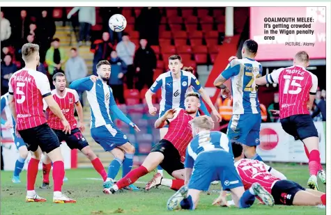  ?? PICTURE: Alamy ?? GOALMOUTH MELEE: It’s getting crowded in the Wigan penalty area