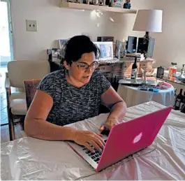  ?? ABBY HOBERMAN ?? Single mother Sharon Litwin works on her laptop at her home in Teaneck, New Jersey. Litwin says two of her friends have become valued sounding boards.