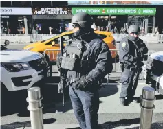  ??  ?? New York Police Department Strategic Response Group members stand in Times Square to provide security ahead of New Year’s Eve celebratio­ns in Manhattan. — Reuters photo