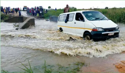  ??  ?? A commuter omnibus crosses a flooded Nyatsime bridge in Chitungwiz­a oblivious of the risk yesterday