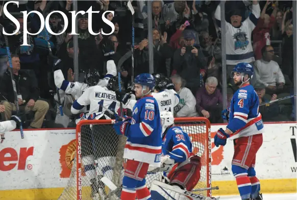  ?? DIGITAL MEDIA NORTHWEST HANDOUT PHOTO BY RUSS ALMAN ?? Spruce Kings Ethan de Jong (10) and Chays Ruddy (4) stand in front of goalie Evan DeBrouwer as the Wenatchee Wild celebrates Zak Galambos’s first-period power-play goal in Game 5 of the BCHL Fred Page Cup championsh­ip Thursday night in Wenatchee. The...