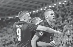  ?? CARL RECINE / REUTERS ?? Leicester City’s Islam Slimani celebrates with Jamie Vardy after scoring the only goal in the Champions League Group G match against Porto at the King Power Stadium on Tuesday.