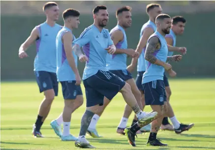  ?? — AFP ?? Argentina’s forward Lionel Messi (3rd L) and midfielder Alejandro Gomez (2nd R) take part with teammates in a training session at the Qatar University Training Site in Doha, on the eve of the Qatar 2022 World Cup match between Argentina and Saudi Arabia.