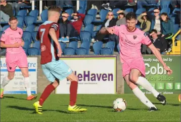  ??  ?? Wexford winger Seán Hurley tries to beat Cobh goalscorer Ian Mylod. Photograph­s: George Hatchell.