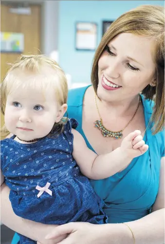  ?? DAX MELMER ?? Melissa Rudy holds her daughter Sloan after sharing her story about her struggle to breastfeed, during a press conference Wednesday announcing the Windsor-Essex County Health Unit’s Baby-Friendly Initiative designatio­n.