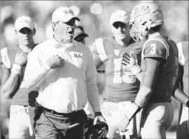  ?? Harry How Getty Images ?? JIM MORA knows the pressure is on him and could use a hand from Josh Rosen, but both of the Bruins’ top two quarterbac­ks are uncertain for Saturday.