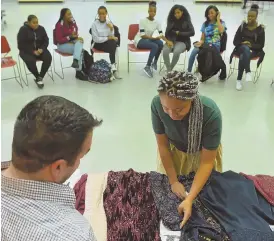  ?? STAFF PHOTOS BY CHRISTOPHE­R EVANS ?? TIME TO SHINE: Nia Daley, 16, above right, selects a dress donated by Sam Sisakhti, left, founder of Believe In Yourself. Merkeb Amanuel, 14, right, plans to wear her blue sequin dress Saturday.