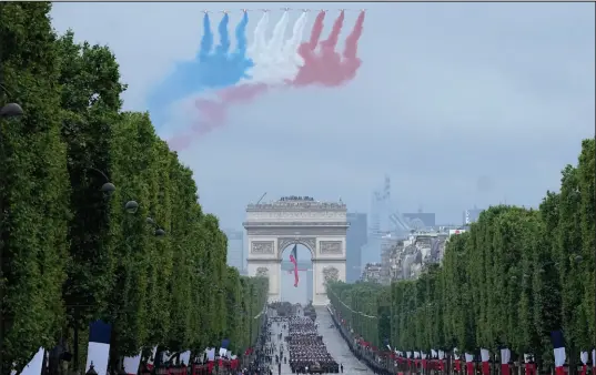  ?? Michel Euler The Associated Press ?? Jets of the Patrouille de France fly Wednesday over the Champs-elysees during the Bastille Day parade in Paris.