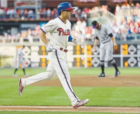  ?? Photos by Matt Slocum, The Associated Press ?? The Phillies’ Scott Kingery rounds the bases after hitting a three-run homer off Rockies starting pitcher Jon Gray, in background, during the first inning Tuesday night in Philadelph­ia.