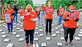  ?? AFP ?? In honour of Internatio­nal Nurses Day and Nurses Week, unionists from the National Nurses United place 400 pairs of shoes on Black Lives Matter Plaza to recognise the registered nurses who have died from the Covid-19 in Washington on Wednesday.
—