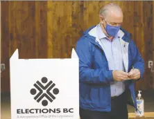  ?? CHAD HIPOLITO/ THE CANADIAN PRESS ?? Opinion polls throughout the campaign have indicated NDP Leader John Horgan, pictured voting on Monday in Langford, is on the verge of winning a majority government.