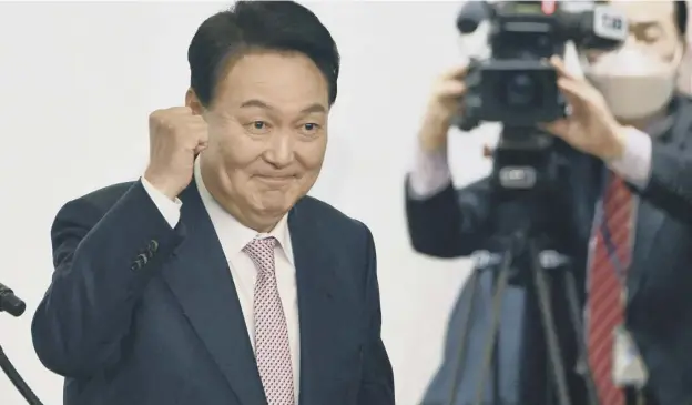  ?? ?? 0 South Korea’s president-elect Yoon Suk-yeol gestures during a ceremony disbanding the presidenti­al election camp at the National Assembly Library in Seoul